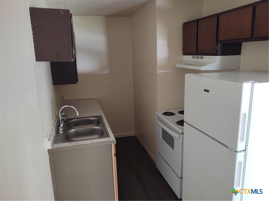 200-220 Quail Run Road Martindale, TX 78655 - Photo 9 of 16 a kitchen with a stove and a microwave