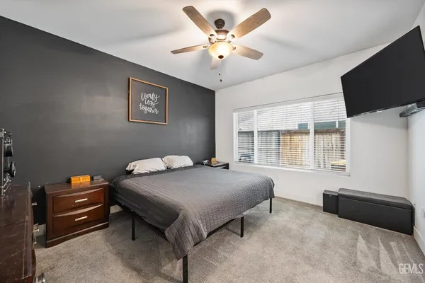 a bed room with a bed and a television