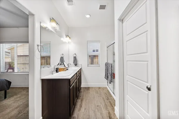 a kitchen with a refrigerator a sink and dishwasher with wooden floor