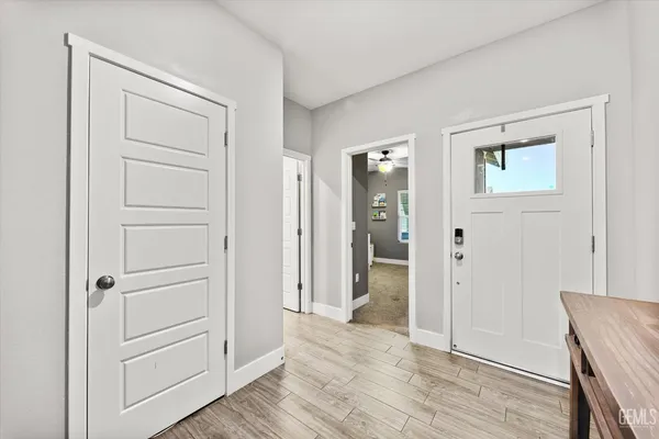 a view of an empty room and wooden floor