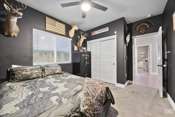 a bedroom with a large bed and a chandelier