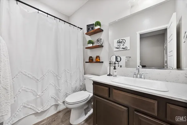 a bathroom with a sink a toilet and vanity