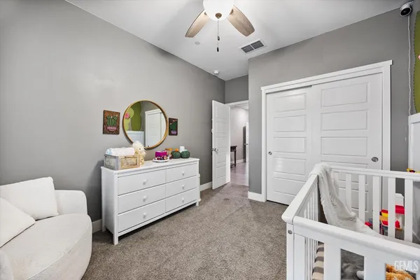 a living room with furniture and a baby crib