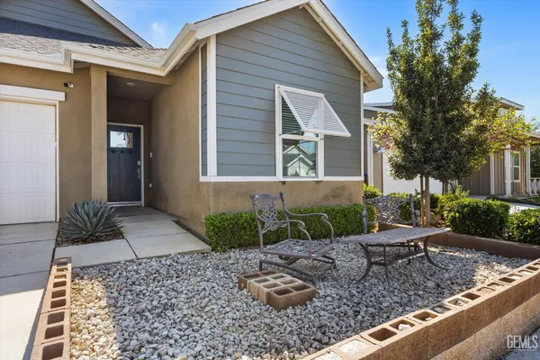 a view of a house with a yard and sitting area