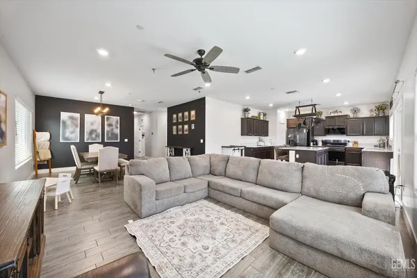 a living room with furniture and kitchen view