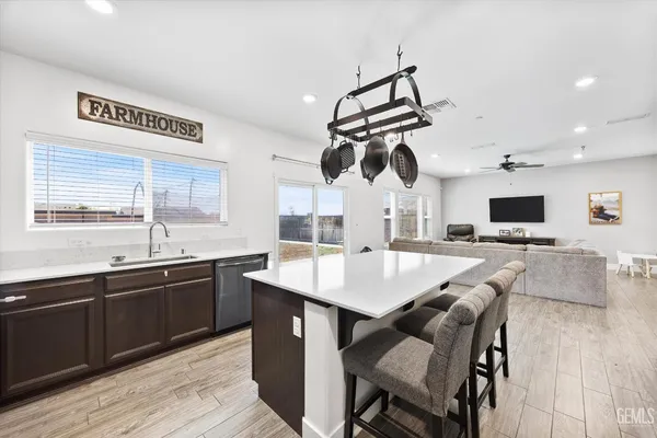 a large kitchen with a table and chairs