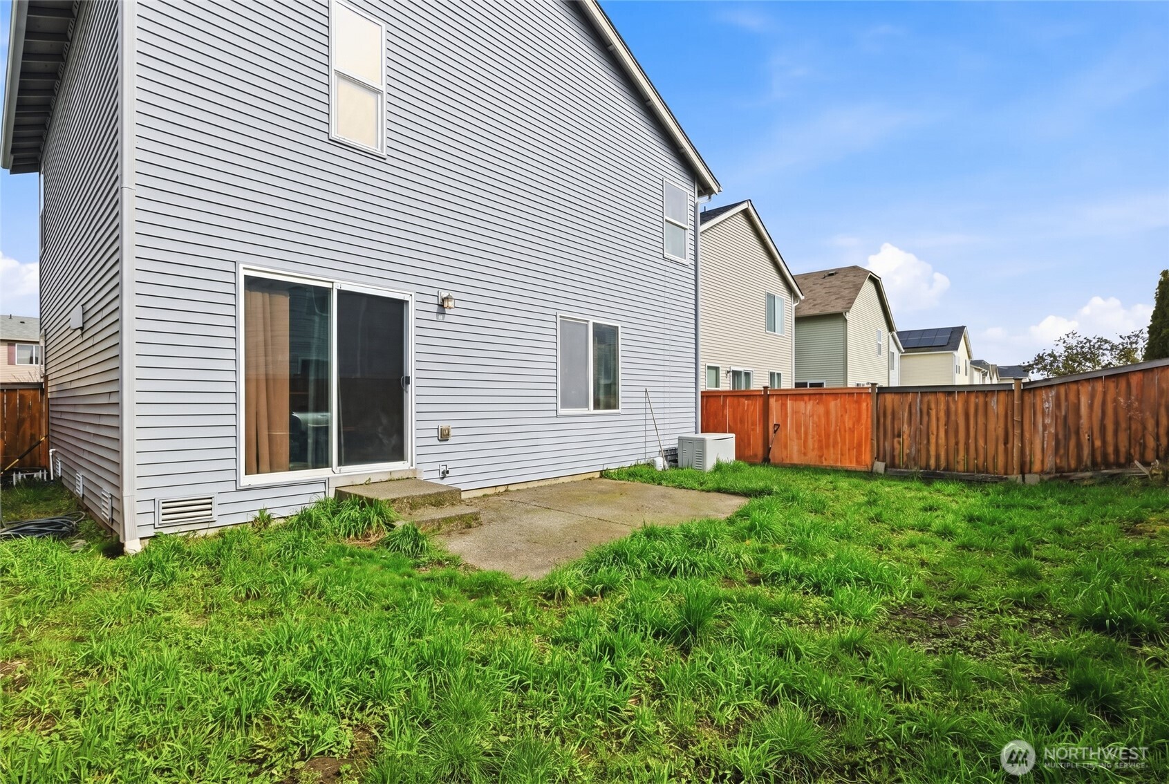 14839 99th Way Southeast Yelm, WA 98597 - Photo 28 of 31 a backyard of a house with wooden fence and large trees