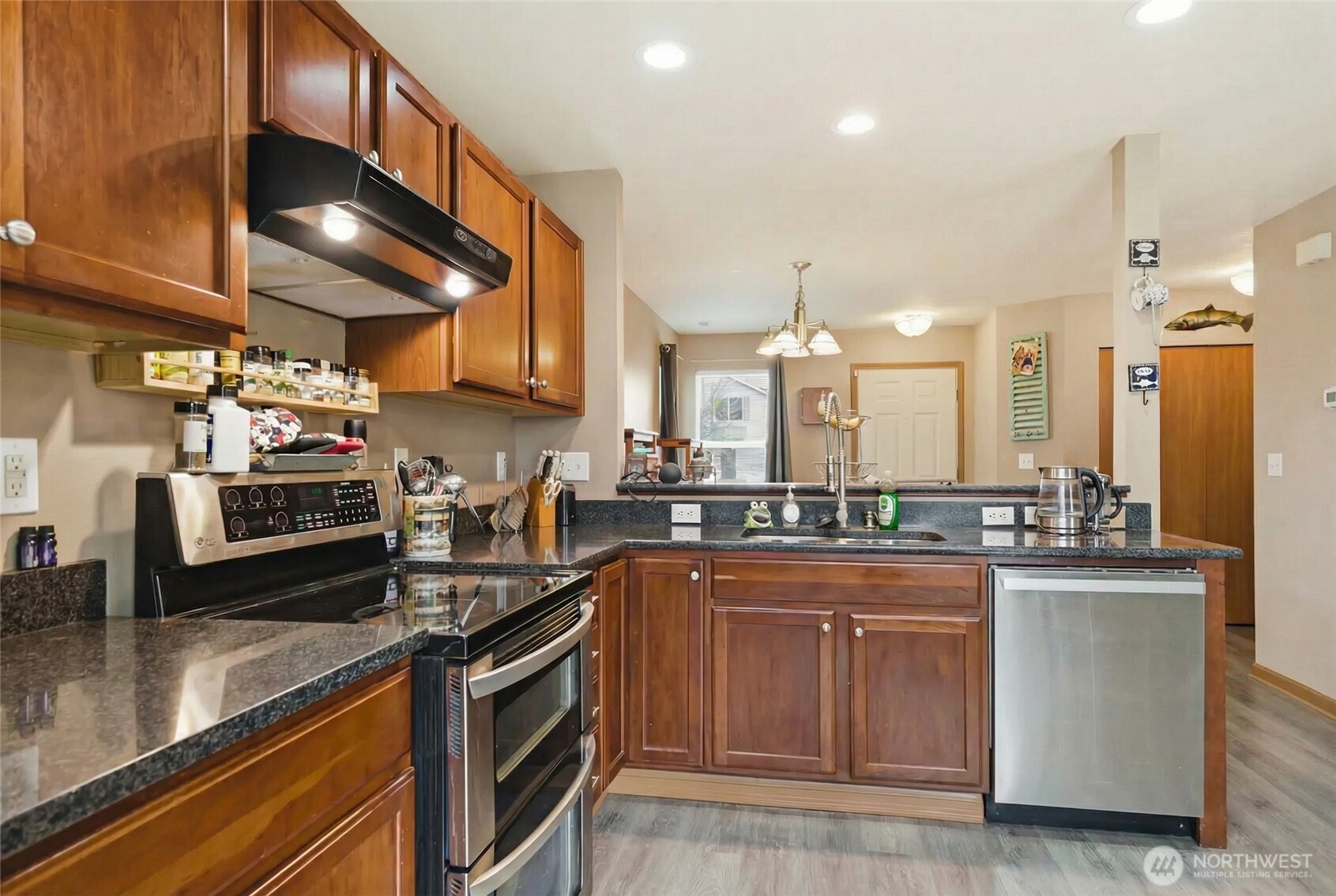 14839 99th Way Southeast Yelm, WA 98597 - Photo 5 of 31 a kitchen with stainless steel appliances a sink stove and cabinets