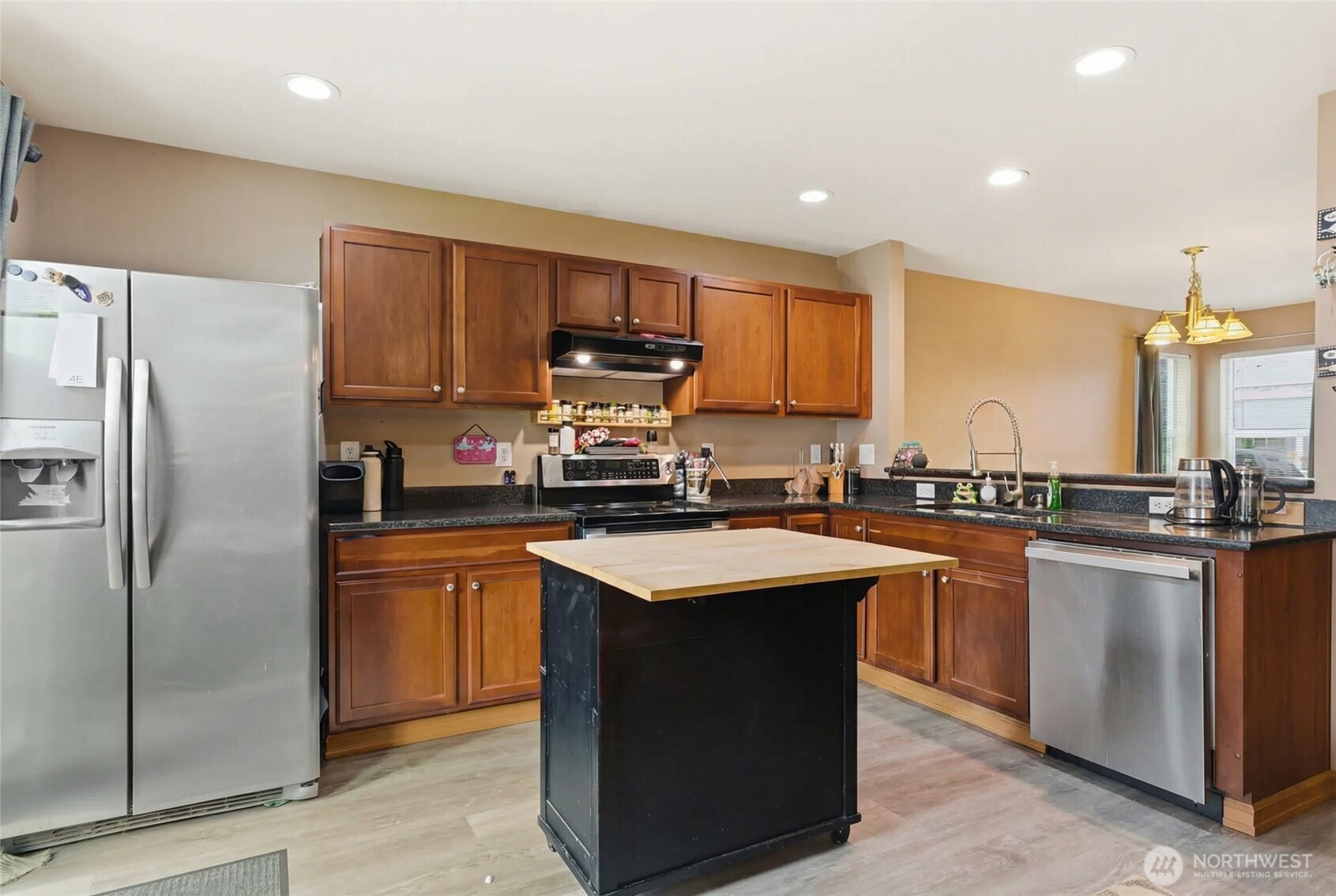 14839 99th Way Southeast Yelm, WA 98597 - Photo 6 of 31 a kitchen with stainless steel appliances granite countertop a refrigerator a sink a stove a microwave and island