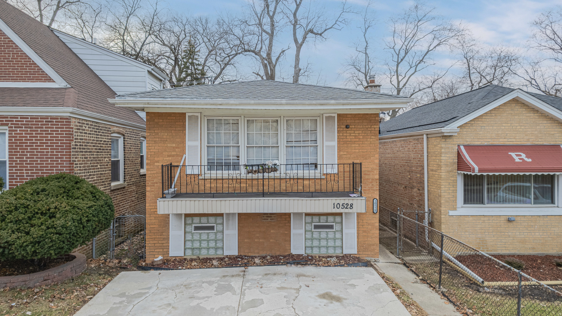 a front view of a house with a garden