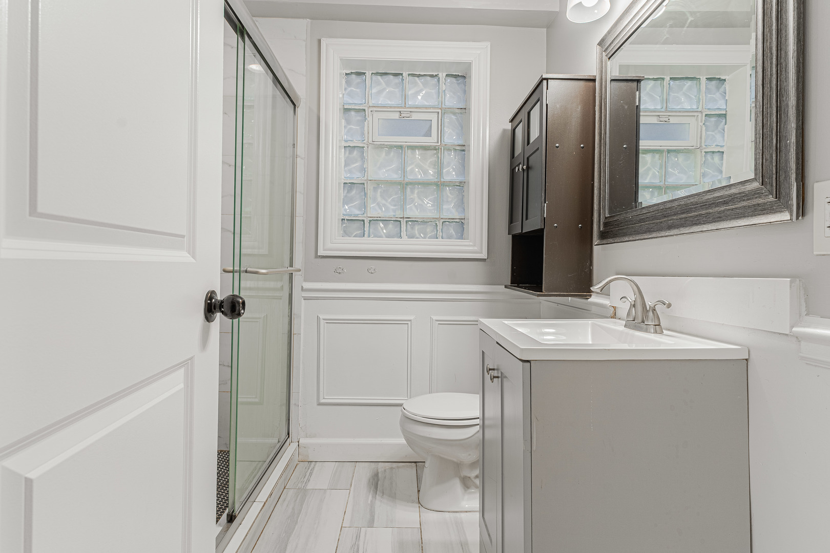 10528 South Aberdeen Street Chicago, IL 60643 - Photo 24 of 33 a bathroom with a sink a toilet and a mirror