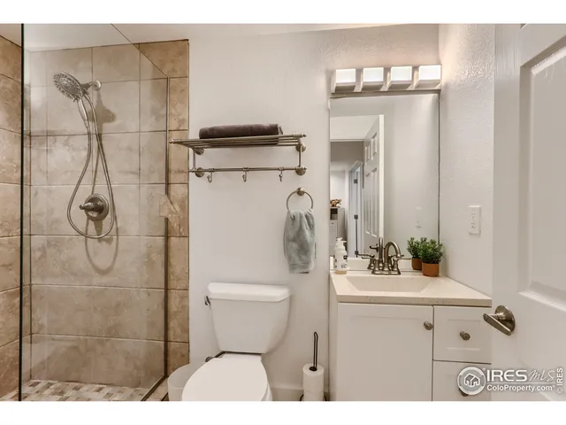 a bathroom with a sink vanity mirror and toilet