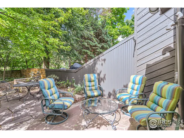 a view of a patio with couple of chairs