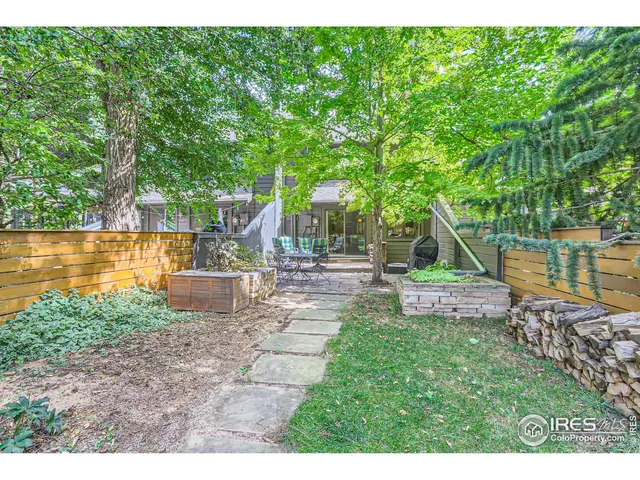 a view of a swimming pool with a patio and a yard