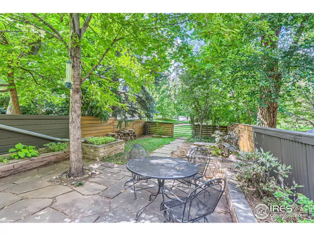 a view of a chair and table in backyard