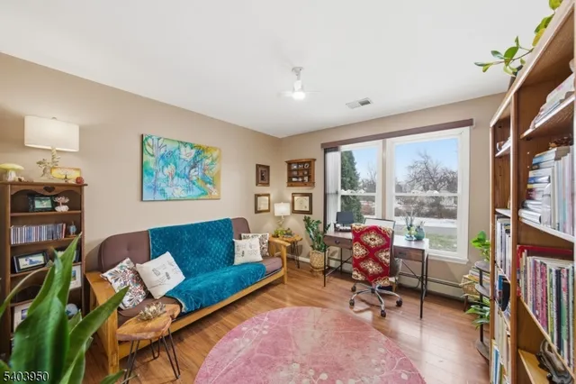 a living room with furniture floor to ceiling window and a flat screen tv