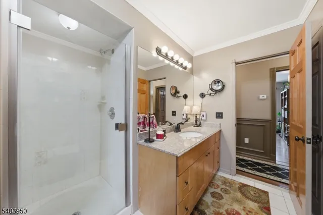 a bathroom with a sink vanity mirror and shower