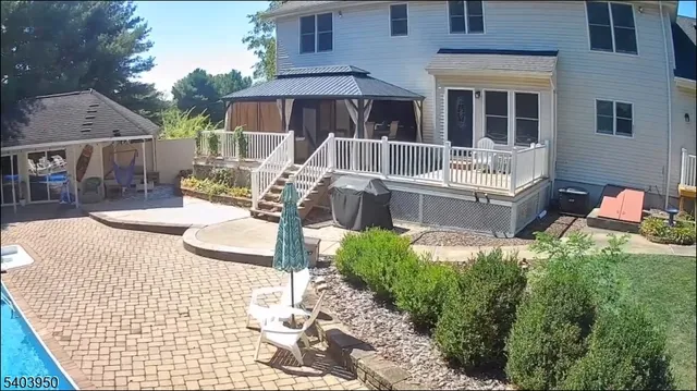 a view of a patio with table and chairs potted plants
