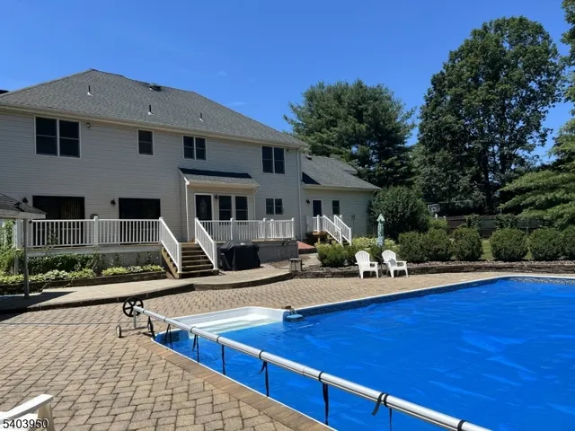 a front view of house with deck and yard