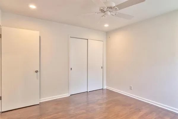 a view of a house with a yard and potted plants