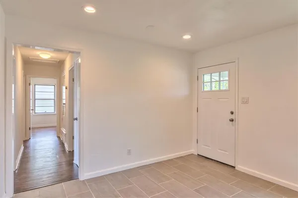 a kitchen with a refrigerator and white cabinets
