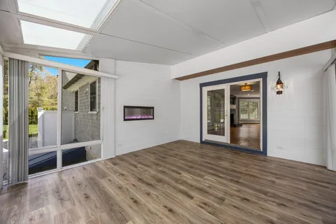 wooden floor in an empty room with a window