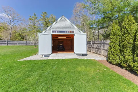 a front view of a house with a yard table and chairs