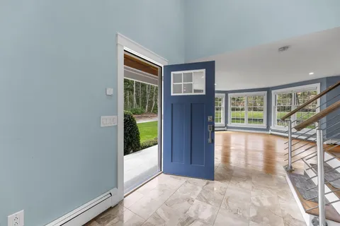 a view of entryway and hall with wooden floor
