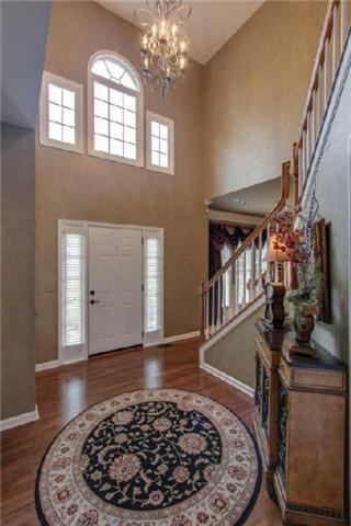 Enter a spacious foyer with gleaming hardwoods!