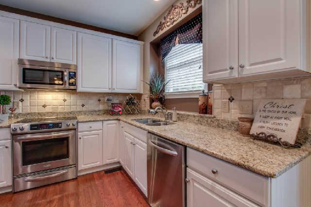 Granite counters, tile backsplashes, stainless appliances, and pantry - The Heart of the Home!