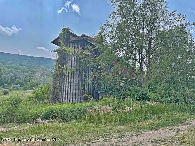a view of a house with a tree in a yard