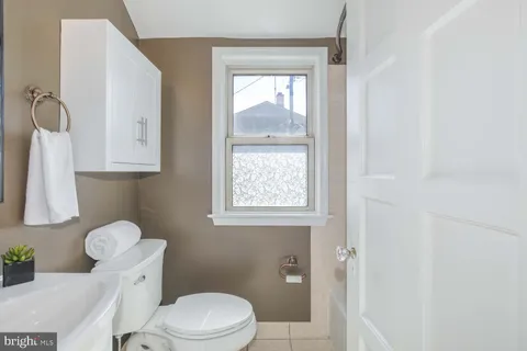 a white toilet sitting next to a bathroom sink