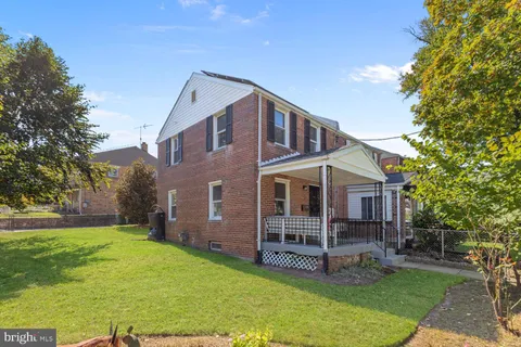 a view of a house with a yard and sitting area