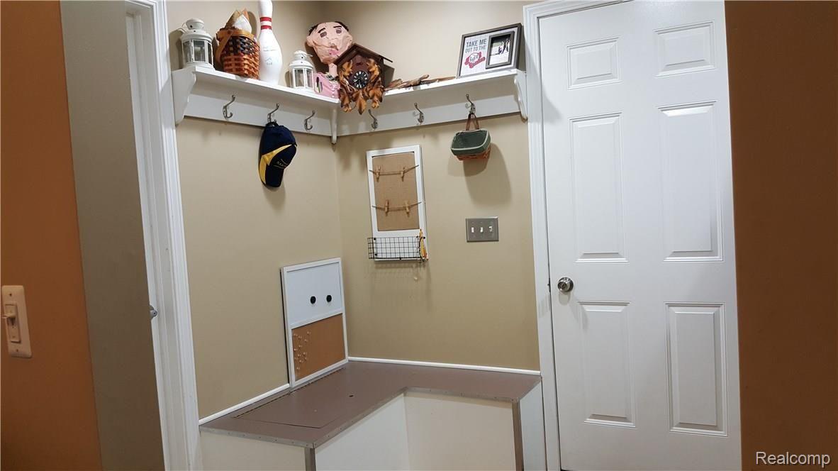 1452 Remsing Street Hartland, MI 48353 - Photo 23 of 24 Entry from Garage, Mud Room with L-cove seating and storage