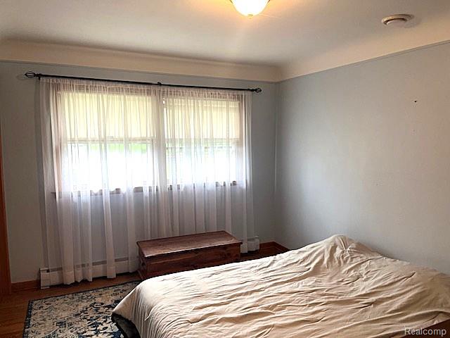 20285 29 Mile Road Ray, MI 48096 - Photo 18 of 25 Double window with white sheer curtains and dark curtain rod