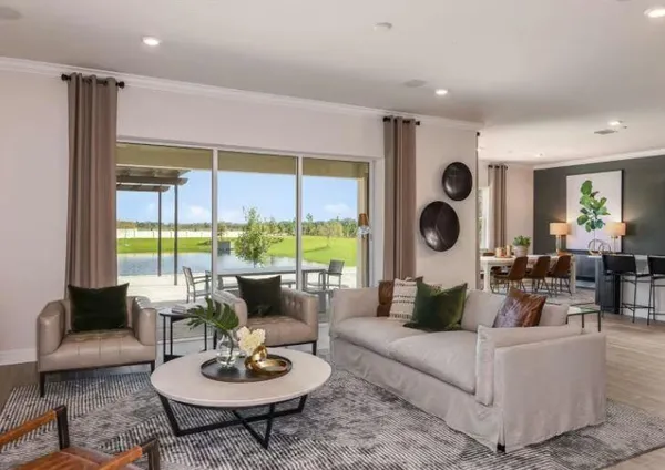 a living room with fireplace furniture and a large window