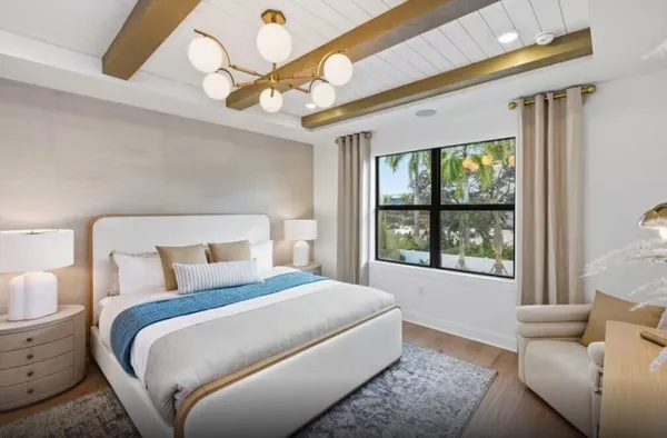 a bedroom with a bed couch and window