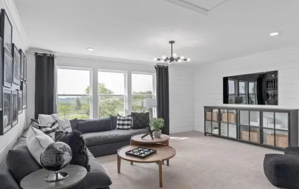 a living room with furniture and a large window