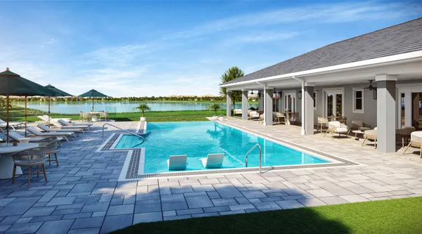 a view of a swimming pool with lawn chairs and a big yard