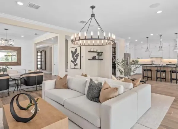 a living room with furniture a chandelier and a chandelier