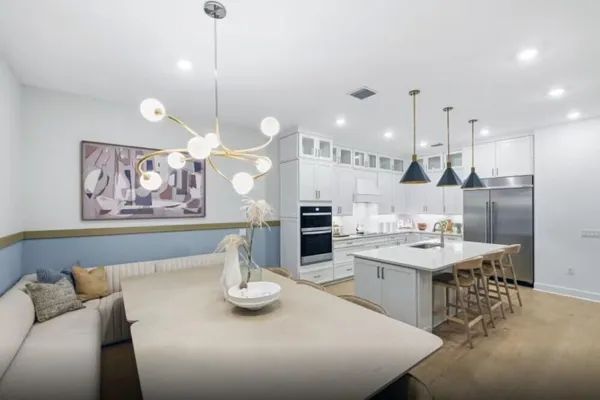 a large kitchen with a table and chairs