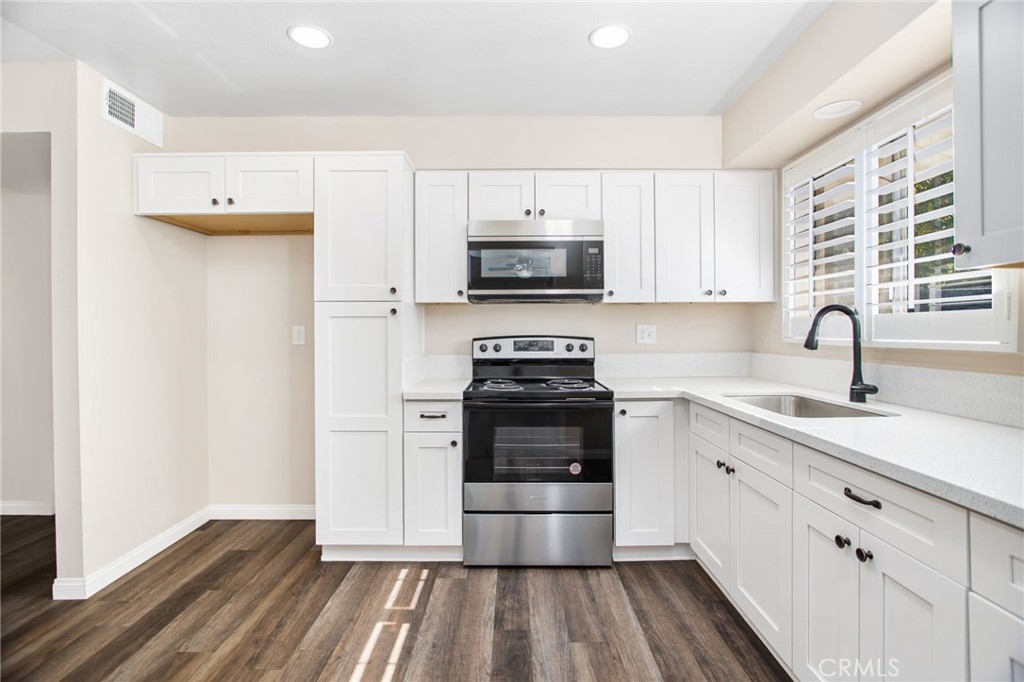 27161 Pinehurst Road Menifee, CA 92586 - Photo 15 of 35 a kitchen with stainless steel appliances a stove sink and microwave