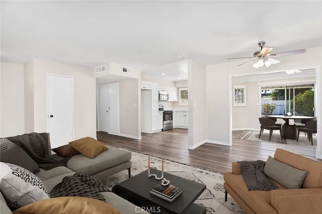 a living room with furniture and wooden floor