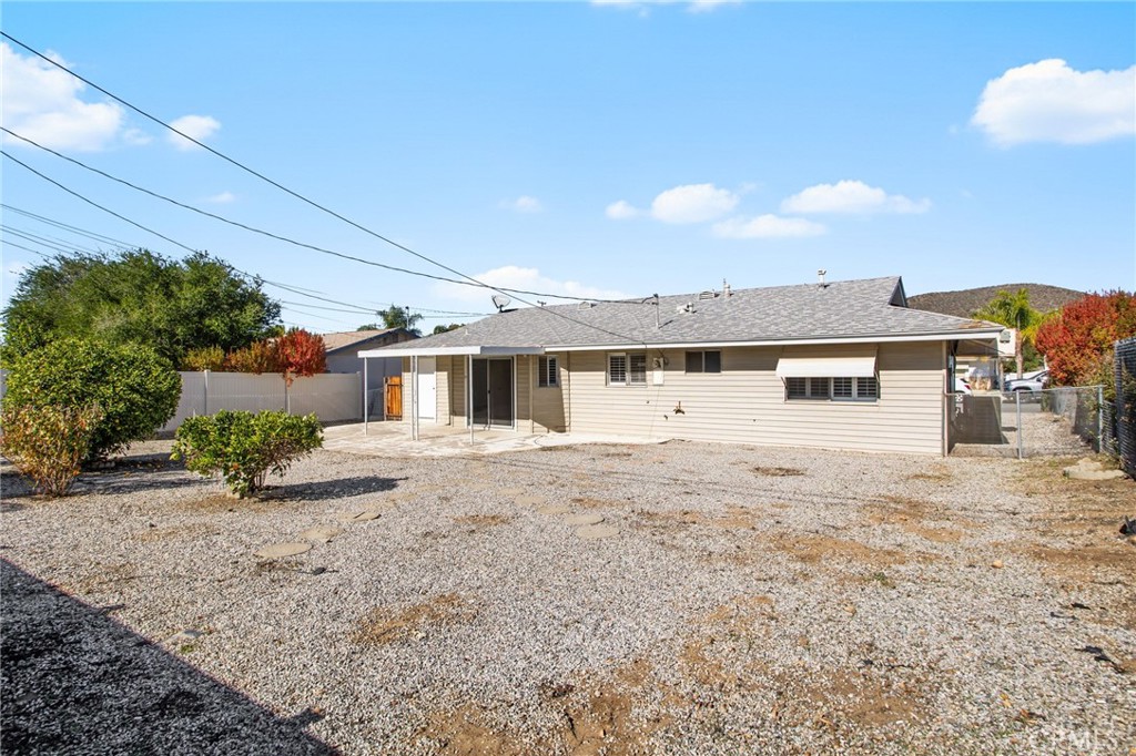 27161 Pinehurst Road Menifee, CA 92586 - Photo 26 of 35 a front view of a house with a yard and garage