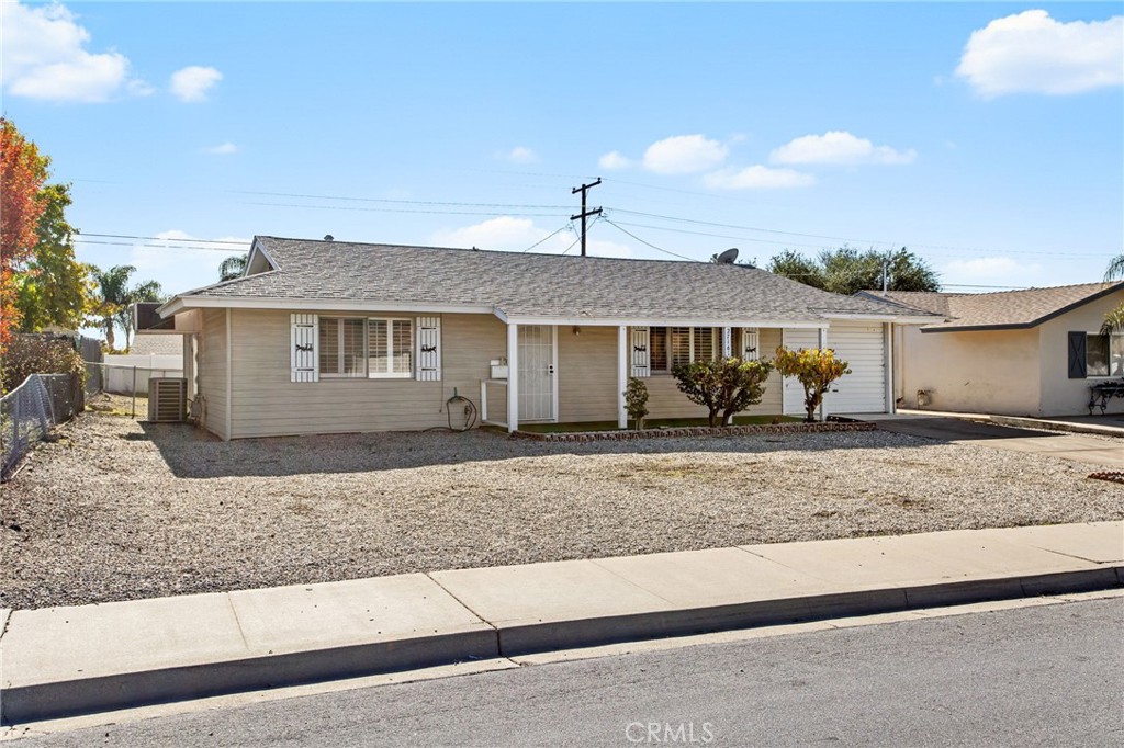 27161 Pinehurst Road Menifee, CA 92586 - Photo 3 of 35 a front view of a house with a yard and covered with trees