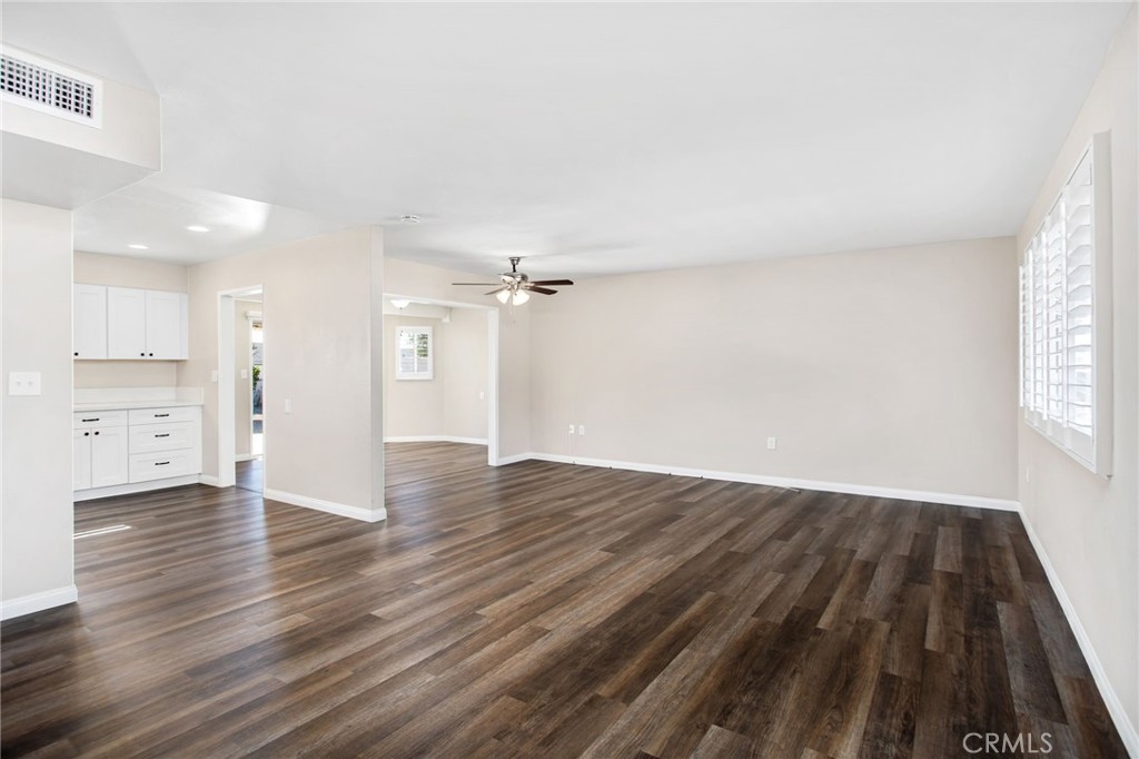 27161 Pinehurst Road Menifee, CA 92586 - Photo 8 of 35 an empty room with wooden floor and windows