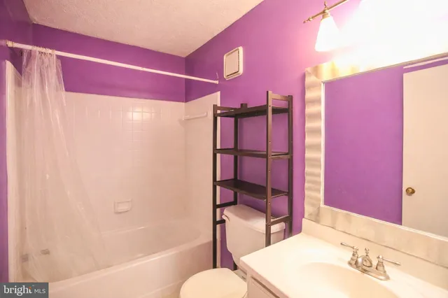 a bedroom with a bed and flat screen tv