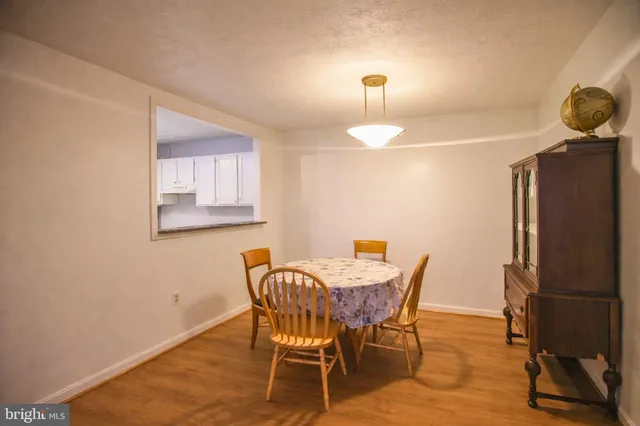 a view of a dining room with furniture and a chandelier