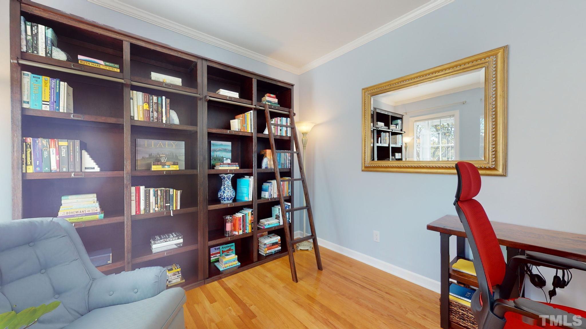 1512 Wood Spring Court Raleigh, NC 27614 - Photo 11 of 39 a living room with fireplace furniture and a book shelf