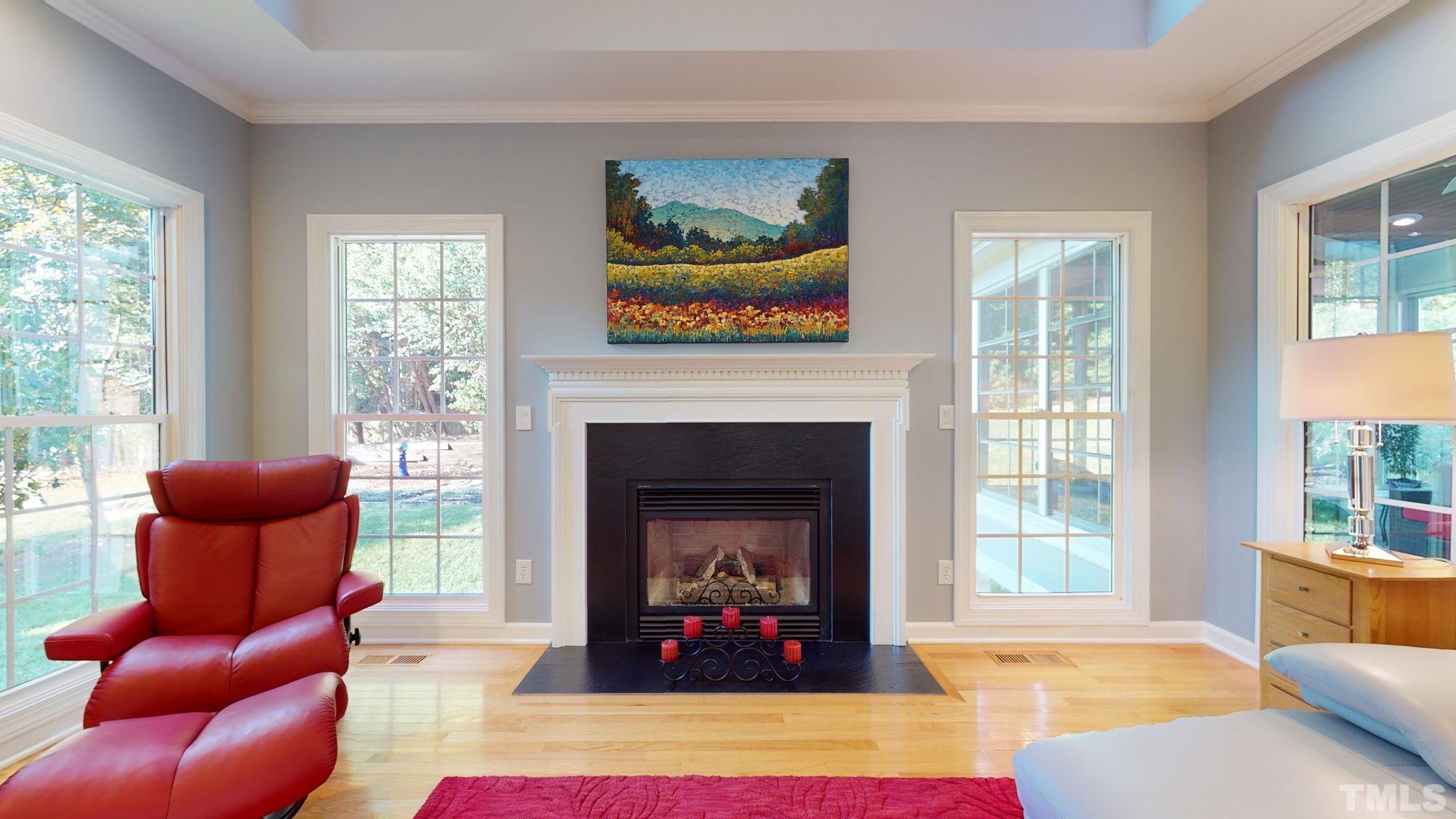 1512 Wood Spring Court Raleigh, NC 27614 - Photo 13 of 39 a living room with furniture a fireplace and windows